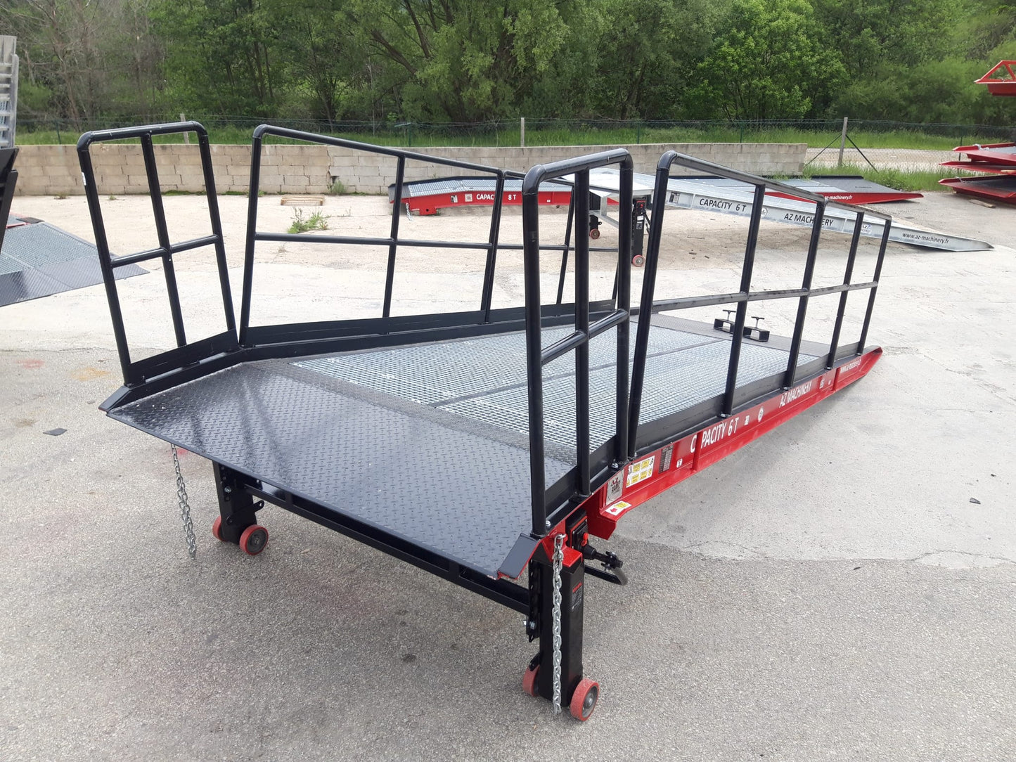 Esta imagen muestra la rampa PRIME XS de AZ RAMP equipada con barandillas de 120 cm de altura. Diseñada para la seguridad en entornos industriales, esta rampa ofrece una capacidad de carga de hasta 6,000 kg y ajuste de altura. ¡Confía en nosotros para optimizar tus operaciones de carga!